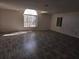 Large living room with high ceilings and laminate wood flooring at 7020 Sena Rd, North Port, FL 34291