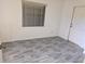 Simple spare bedroom with laminate wood flooring and a door at 7020 Sena Rd, North Port, FL 34291