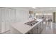 Ocean view kitchen features a large island, white cabinetry, and gas cooktop at 709 Key Royale Dr, Holmes Beach, FL 34217