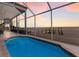 Inviting pool with a screened enclosure and stunning sunset views at 709 Key Royale Dr, Holmes Beach, FL 34217