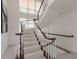 Elegant staircase with wooden railings and carpeted steps at 709 Key Royale Dr, Holmes Beach, FL 34217