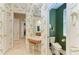 Bathroom with double vanity, separate toilet area, and green accent wall at 7215 Treymore Ct, Sarasota, FL 34243