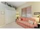 Relaxing bedroom with a striped sofa, window blinds, and a double door closet at 7215 Treymore Ct, Sarasota, FL 34243