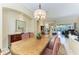 Elegant dining room featuring a large wood table, chandelier, and access to the pool at 7215 Treymore Ct, Sarasota, FL 34243