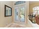 Bright and airy entryway with double doors and a decorative mirror at 7215 Treymore Ct, Sarasota, FL 34243