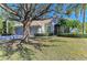 Single-story home with a large oak tree in the front yard and a two-car garage at 7215 Treymore Ct, Sarasota, FL 34243