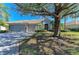 Single-story home with a two-car garage and a large oak tree in the front yard at 7215 Treymore Ct, Sarasota, FL 34243