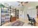 Home office features built-in shelving, hardwood floors, and a view of the living area at 7215 Treymore Ct, Sarasota, FL 34243