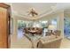 Spacious living room featuring a leather sectional sofa, large windows, and hardwood floors at 7215 Treymore Ct, Sarasota, FL 34243