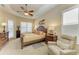 Bright main bedroom with a king-size bed, plantation shutters, and ensuite bathroom at 7215 Treymore Ct, Sarasota, FL 34243