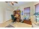 Bright home office with wood desk and built-in shelving at 7215 Treymore Ct, Sarasota, FL 34243