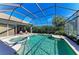 Inviting screened-in pool and spa, perfect for relaxation at 7215 Treymore Ct, Sarasota, FL 34243