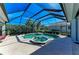 Screened-in pool and spa with a spacious deck and lush landscaping at 7215 Treymore Ct, Sarasota, FL 34243