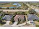 Aerial view of a house near a lake and road at 7302 Deer Crossing Ct, Sarasota, FL 34240