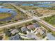 Aerial view of a residential area with houses and a lake, ideal for waterfront living at 7302 Deer Crossing Ct, Sarasota, FL 34240