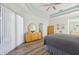 Main bedroom with large dresser, mirrored vanity, and sliding glass doors at 7302 Deer Crossing Ct, Sarasota, FL 34240