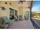 Relaxing screened porch with patio furniture and view of backyard at 7302 Deer Crossing Ct, Sarasota, FL 34240