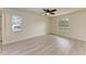 Spacious bedroom featuring wood-look floors and a ceiling fan at 7930 Verna Bethany Rd, Myakka City, FL 34251