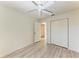 Well-lit bedroom with wood-look floors and a double door closet at 7930 Verna Bethany Rd, Myakka City, FL 34251