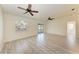 Bright living room with hardwood floors and sliding door at 7930 Verna Bethany Rd, Myakka City, FL 34251