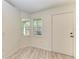 Bright spare bedroom with wood-look floors and large window at 7930 Verna Bethany Rd, Myakka City, FL 34251