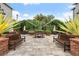 Community patio with seating, tables, and lush landscaping at 800 S Dakota Ave # 329, Tampa, FL 33606