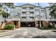 Condo building with parking garage and landscaping at 800 S Dakota Ave # 329, Tampa, FL 33606