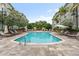 Community pool with lounge chairs and patio area at 800 S Dakota Ave # 329, Tampa, FL 33606