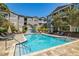 Inviting community swimming pool with surrounding lounge chairs at 800 S Dakota Ave # 329, Tampa, FL 33606