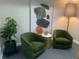 Modern waiting area features two green armchairs, a side table, and large artwork at 800 S Dakota Ave # 329, Tampa, FL 33606