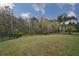 Large backyard with grass and black metal fence creating a private outdoor space at 8030 Hampton Lake Dr, Tampa, FL 33647