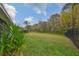 Large backyard with fenced in area and grassy lawn at 8030 Hampton Lake Dr, Tampa, FL 33647