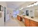 Bright bathroom featuring a soaking tub, double vanity, and tiled floor at 8030 Hampton Lake Dr, Tampa, FL 33647