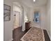 Bright entryway with dark hardwood floors, decorative rug, and a console table at 8030 Hampton Lake Dr, Tampa, FL 33647