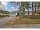 Charming one-story home with a light teal exterior and palm trees at 8030 Hampton Lake Dr, Tampa, FL 33647