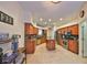 Well-lit kitchen with stainless steel appliances, granite countertops, an island, and an adjacent dining area at 8030 Hampton Lake Dr, Tampa, FL 33647