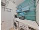 Bright laundry room with washer, dryer, and ample shelving at 8030 Hampton Lake Dr, Tampa, FL 33647