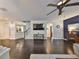 Bright living room with hardwood floors, ceiling fan and adjacent staircase to the second floor at 8030 Hampton Lake Dr, Tampa, FL 33647