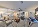 Spacious living room featuring hardwood floors, a modern ceiling fan, and an open layout into the dining area at 8030 Hampton Lake Dr, Tampa, FL 33647