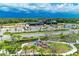 Aerial view of community features including clubhouse, playground, and landscaping at 8250 Velda Trl, Sarasota, FL 34241