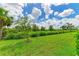 Lush green backyard with manicured lawn at 8250 Velda Trl, Sarasota, FL 34241