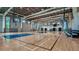 Indoor gymnasium with basketball court featuring polished hardwood floors and ample seating at 8250 Velda Trl, Sarasota, FL 34241