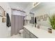 Clean bathroom with gray vanity and shower/tub combo at 8250 Velda Trl, Sarasota, FL 34241