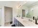 Elegant bathroom with double vanity, large mirror, and walk-in shower at 8250 Velda Trl, Sarasota, FL 34241