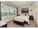 Bright bedroom with large window, plush bed, and stylish decor at 8250 Velda Trl, Sarasota, FL 34241