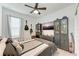 Cozy bedroom with mounted TV, multiple guitars, and ample storage at 8250 Velda Trl, Sarasota, FL 34241