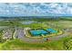 Aerial view of the community park with tennis courts, sports fields, and walking paths amidst a scenic landscape at 8250 Velda Trl, Sarasota, FL 34241