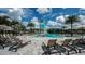 Resort-style community pool with a water slide, splash pad, lounge chairs, and umbrella tables for a luxurious experience at 8250 Velda Trl, Sarasota, FL 34241