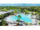 Aerial view of a resort-style community pool featuring spacious deck, lounge chairs and splashpad at 8250 Velda Trl, Sarasota, FL 34241