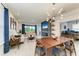 Open concept dining room with a large wooden table and modern chandelier at 8250 Velda Trl, Sarasota, FL 34241